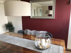 a living room with a table and a mirror at Feriendoppelhaushälfte Böttcher in Meeschendorf
