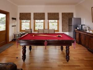 a room with a pool table in a kitchen at Ambience on Huon Bed & Breakfast in Cygnet