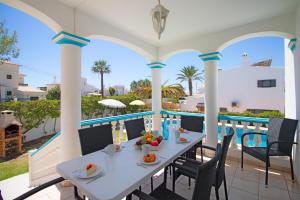 a dining table on the balcony of a house at Villa Azul in Guia