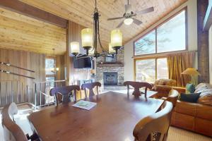 a dining room with a large wooden table and chairs at Woodlands 34 in Mammoth Lakes