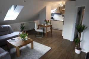 a living room with a couch and a table at Ferienwohnung Am See 2 in Rhauderfehn