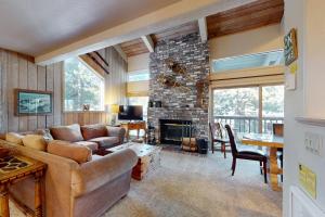 a living room with a couch and a fireplace at Chamonix 100 in Mammoth Lakes