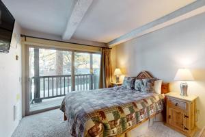 a bedroom with a bed and a large window at Chamonix 100 in Mammoth Lakes +95 photos