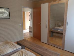 a bedroom with a door leading to a bed at Ferienwohnung Am See 1 in Rhauderfehn +17 photos