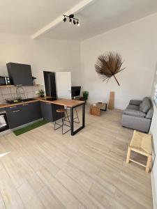 a living room with a table and a couch at Appartement au centre de Gosier 7 in Le Gosier