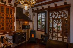 a living room with a stove and a window at ALOJAMIENTO MAZARI in Antequera