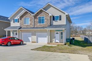 a house with a red car parked in a driveway at 6 Mi to PNC Music Pavilion Concord Townhome in Concord