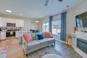 a living room with a couch and a kitchen at 6 Mi to PNC Music Pavilion Concord Townhome in Concord