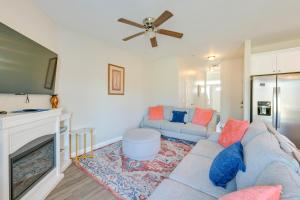a living room with a blue couch and a fireplace at 6 Mi to PNC Music Pavilion Concord Townhome in Concord