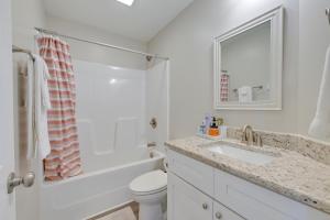 a bathroom with a sink and a toilet and a mirror at 6 Mi to PNC Music Pavilion Concord Townhome in Concord +20 photos