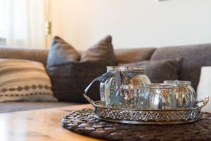 a tray with a silver tea set on a table at Ferienhof Böhnke Nr3 in Puttgarden