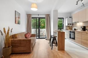 a living room with a couch and a kitchen at Maia Apartment with One Bedroom & Fully kitchen in Bucharest