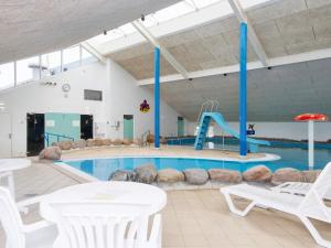 a swimming pool with a slide in a building at Holiday home Hemmet CIII in Hemmet +50 photos