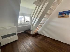 a room with a staircase with a window at Haus am Stadtpark in Burg auf Fehmarn