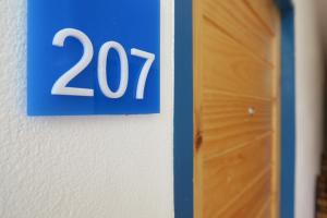 a blue sign on a wall next to a door at Hotel Montha in Chiang Mai +14 photos