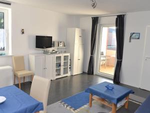 a living room with a tv and a table and chairs at Fewo 91 WHG B 19 in Burhave in Burhave