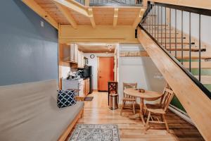 a tiny house with a staircase and a table at Snowline Lodge Condo 18 - Beautifully Remodeled! in Glacier