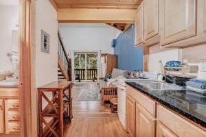 a kitchen with wooden cabinets and a counter top at Snowline Lodge Condo 18 - Beautifully Remodeled! in Glacier +11 photos