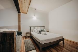 a bedroom with a bed with white sheets and pillows at Snowline Lodge Condo 18 - Beautifully Remodeled! in Glacier