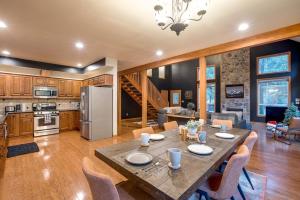 a kitchen and living room with a table and chairs at Glacier Springs Cabin 20 - Elegant Country Home in Glacier