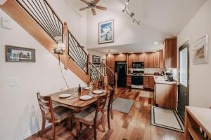 a kitchen and dining room with a table and chairs at Mt, Baker Rim Cabin 77 - Hot Tub - Wi-Fi - Evc - Pets Ok - Views in Glacier