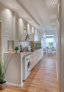a kitchen with a washer and dryer at Strandburg Aquamarin in Burgtiefe auf Fehmarn 