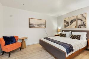 a bedroom with a bed and a chair at Riverfront w Cedar Hottub, Sauna, Movie Theatre in Granite Falls