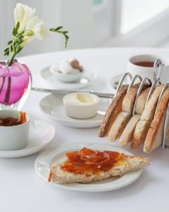 a white table topped with plates of food and desserts at Burgh Island Hotel in Bigbury on Sea