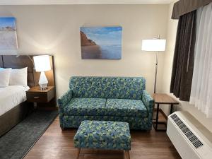 a hotel room with a couch and a bed at Old Town Inn in San Diego