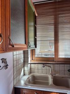 a kitchen with a sink and a window and a tub at Studio with garden in Selínia +18 photos