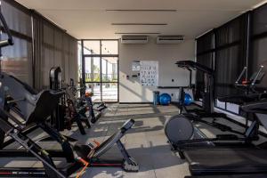 a gym with a bunch of exercise bikes in it at Move #914 - Apartamento Confortável by Carpediem in Tambaú