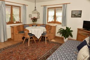 a living room with a table and chairs at Haus Savoy - Appartement 4 in Kitzbühel