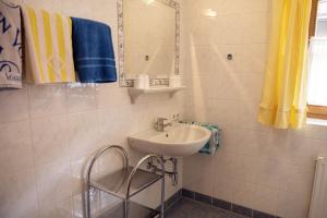 a bathroom with a sink and a mirror at Haus Savoy - Appartement 4 in Kitzbühel