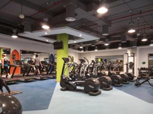 a gym with a bunch of treadmills and machines at Luxurious Brand New 2BR Apartment in Rimal 1 I Steps to the JBR Beach I GYL Holiday Homes in Dubai