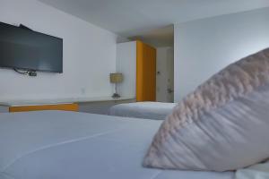 Postel nebo postele na pokoji v ubytování Aristos Express CDMX