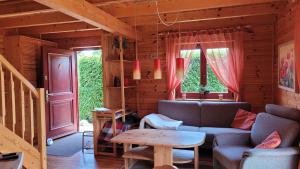 a living room with a couch and a table at Ferienhaus Bliev-Hee Nr 1 in Klink