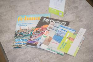 a pile of publications sitting on top of a table at Scheune 8 in Gollendorf