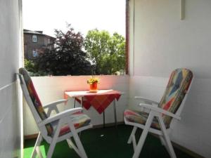 a small table and two chairs on a patio at Fewo 91 WHG B 18 in Burhave in Burhave +4 photos