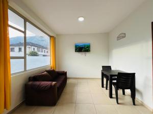 a living room with a couch and a table at Cascada Apartment 3 Bedrooms 2 Bath in Baños