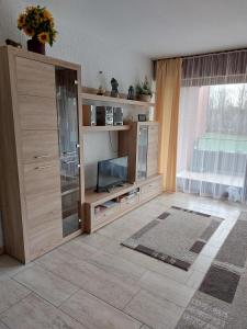 a living room with a entertainment center with a flat screen tv at Appartment 025 in Tossens in Tossenserdeich