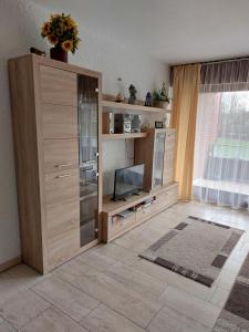 a large wooden entertainment center with a flat screen tv at Appartment 025 in Tossens in Tossenserdeich