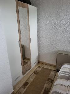 a white room with a mirror and a bed at Appartment 025 in Tossens in Tossenserdeich +12 photos