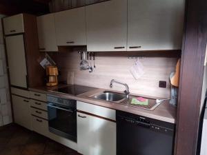 a small kitchen with a sink and a stove at Bungalow M 43 in Burhave in Burhave