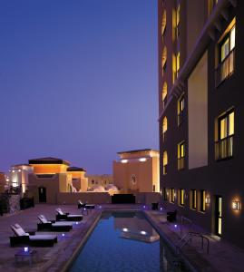 a swimming pool in the middle of a building at Traders Hotel, Abu Dhabi in Abu Dhabi