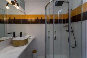 a bathroom with a shower and a sink at Penedo Escape Sea Suites in Colares