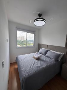 a bedroom with a large bed with a window at Laguna 380 in Sao Paulo