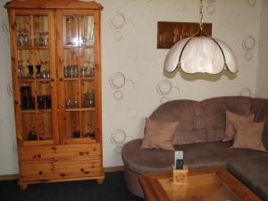 a living room with a couch and a cabinet with wine glasses at Hering in Grossenbrode