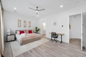 a bedroom with a bed and a desk and a table at BRs w Ensuite Baths l Pet-Friendly l Central Loc in Dallas +21 photos