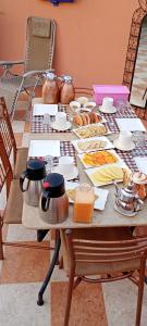 a table with food and utensils on it at Dar Kouzzou in Marrakech