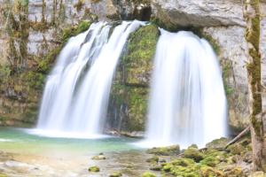 a waterfall on the side of a rock wall at Appartement moderne avec jardin, quartier calme in Saint-Claude +7 photos
